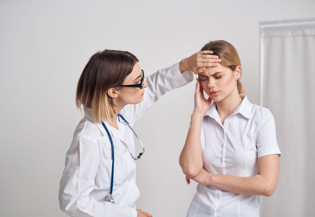 Doctor measuring her patients temperature.