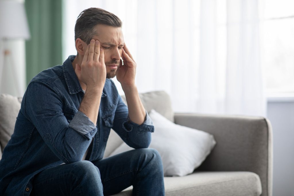 A stressed man having a headache.