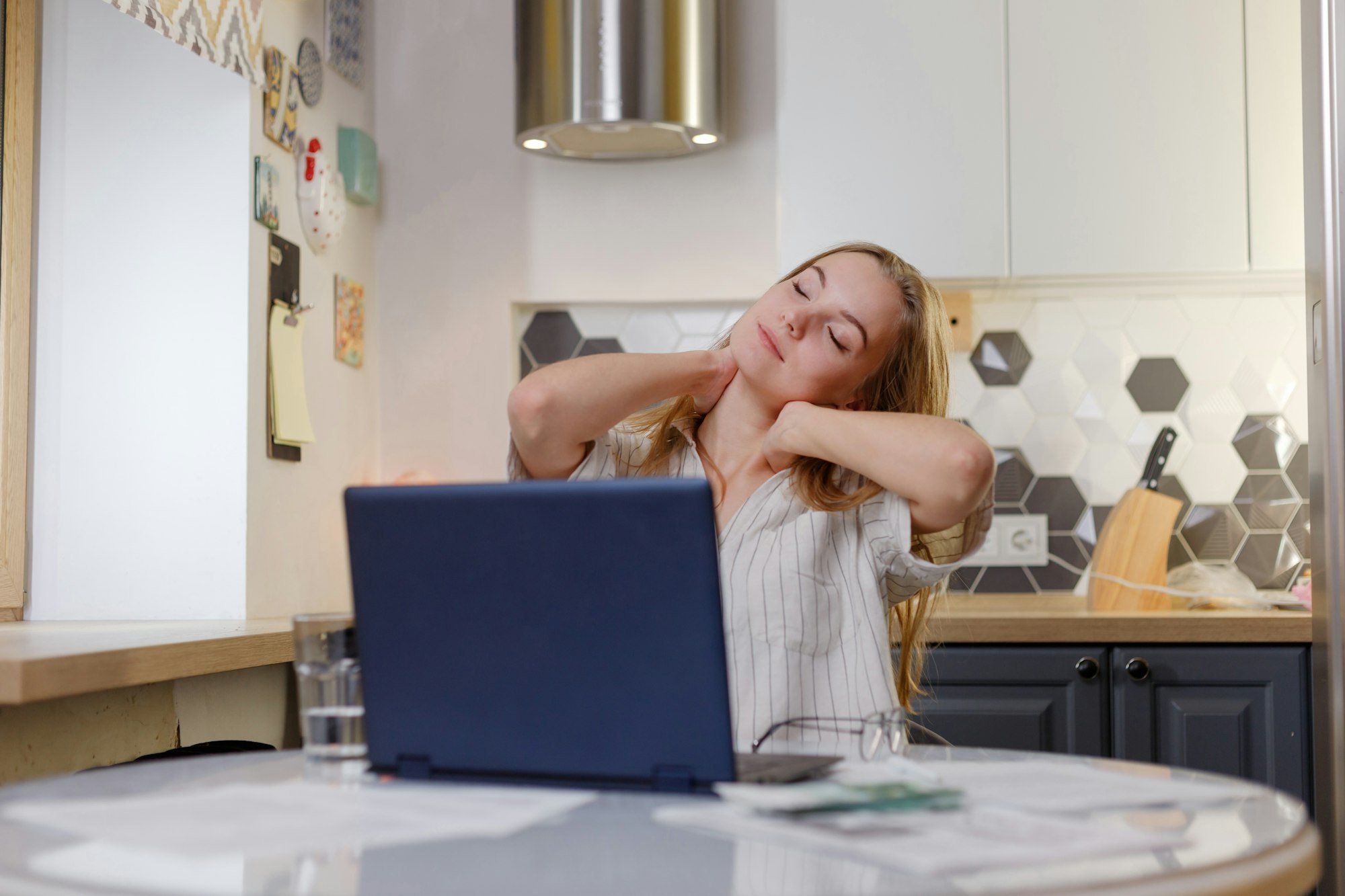 woman working on pc laptop suffering from neck pain, osteochondrosis, muscle spasm