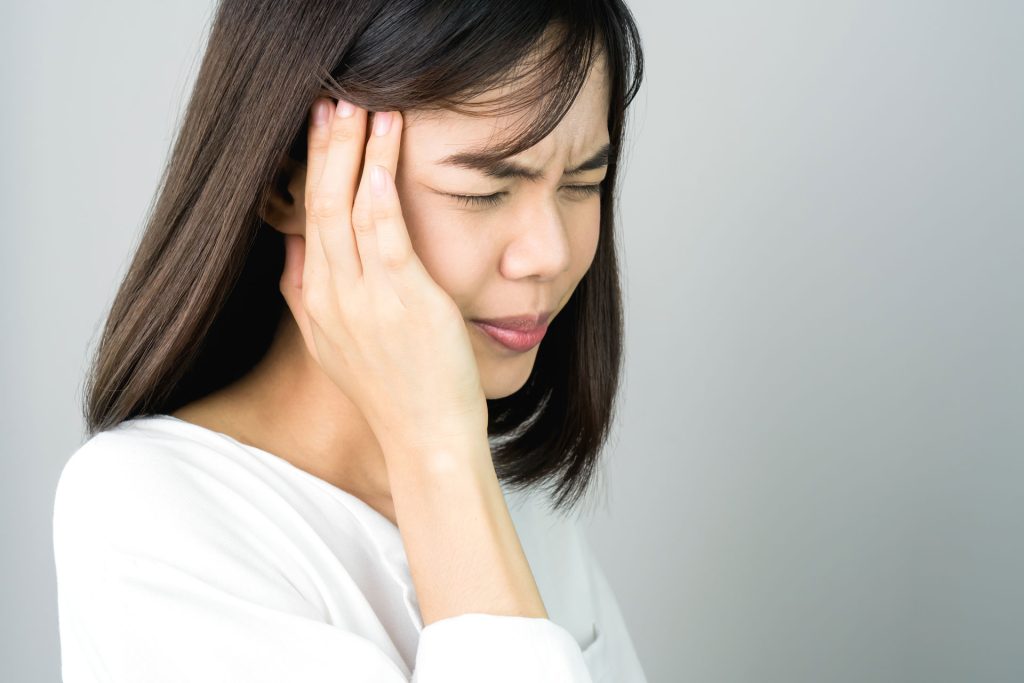 A woman with Trigeminal Neuralgia having a headache.