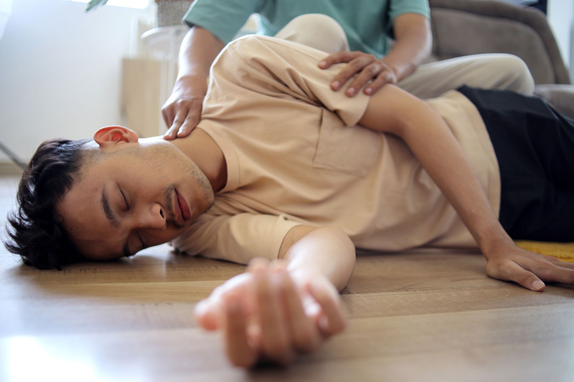 Man lying unconscious in the floor.