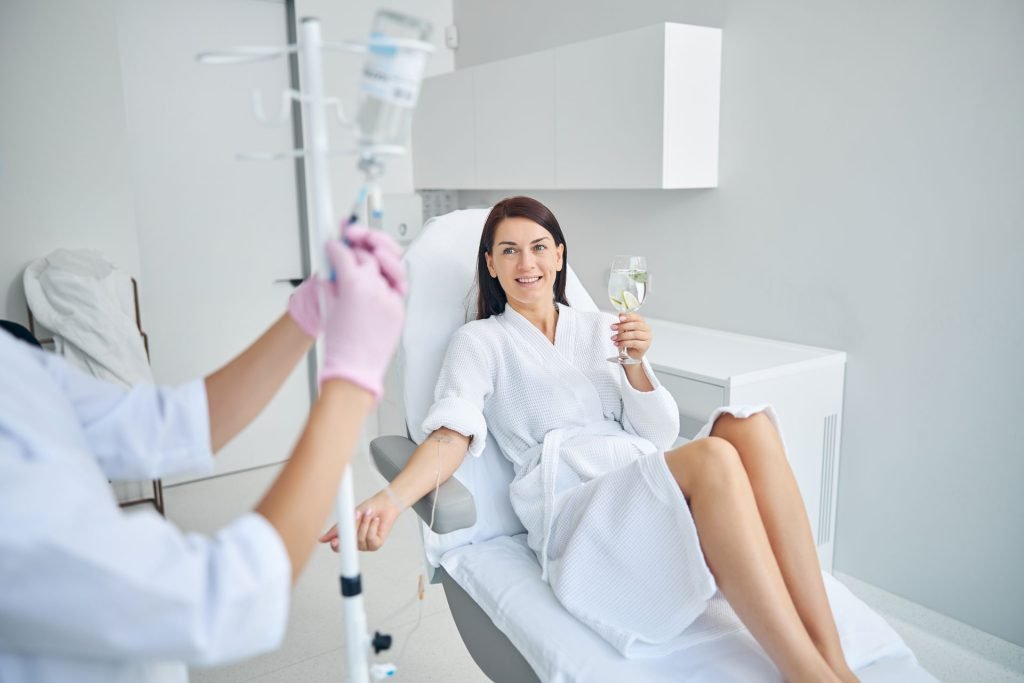 Woman relaxing and having IV therapy.
